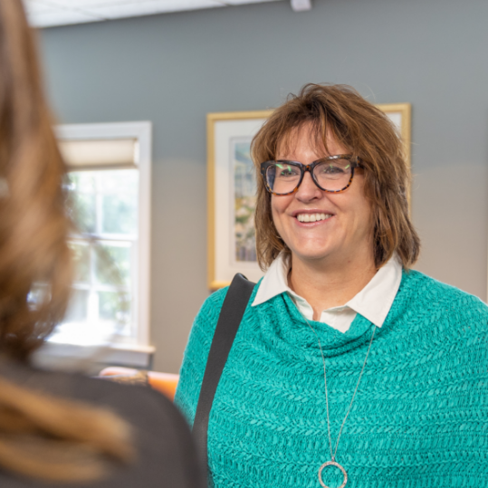 Newton dental team member talking to a patient at front desk