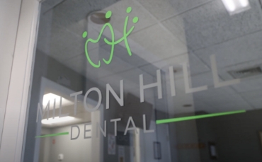 Milton Hill Dental sign on a wood wall